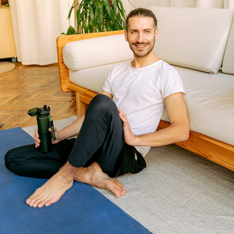 Yoga mat, water bottle, and comfortable clothes ready for a class.